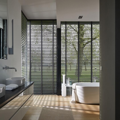 Bathroom with tall windows and timber venetian blind