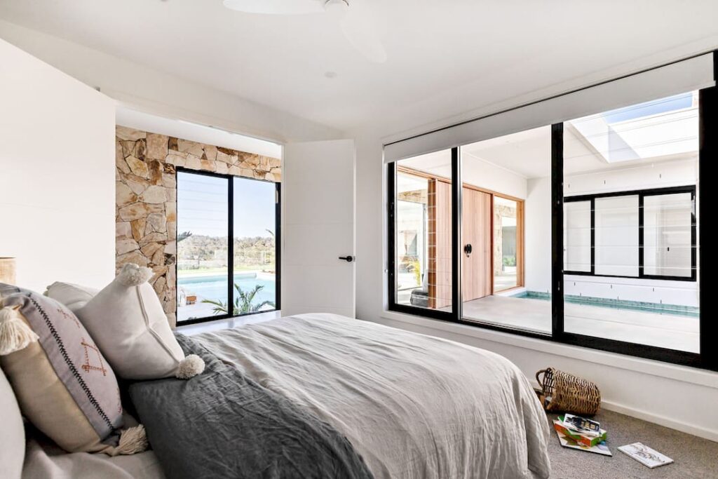 Homeowner adjusting blinds for privacy