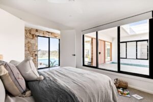 Homeowner adjusting blinds for privacy