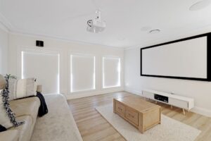 Couple installing blockout blinds in Aussie living room
